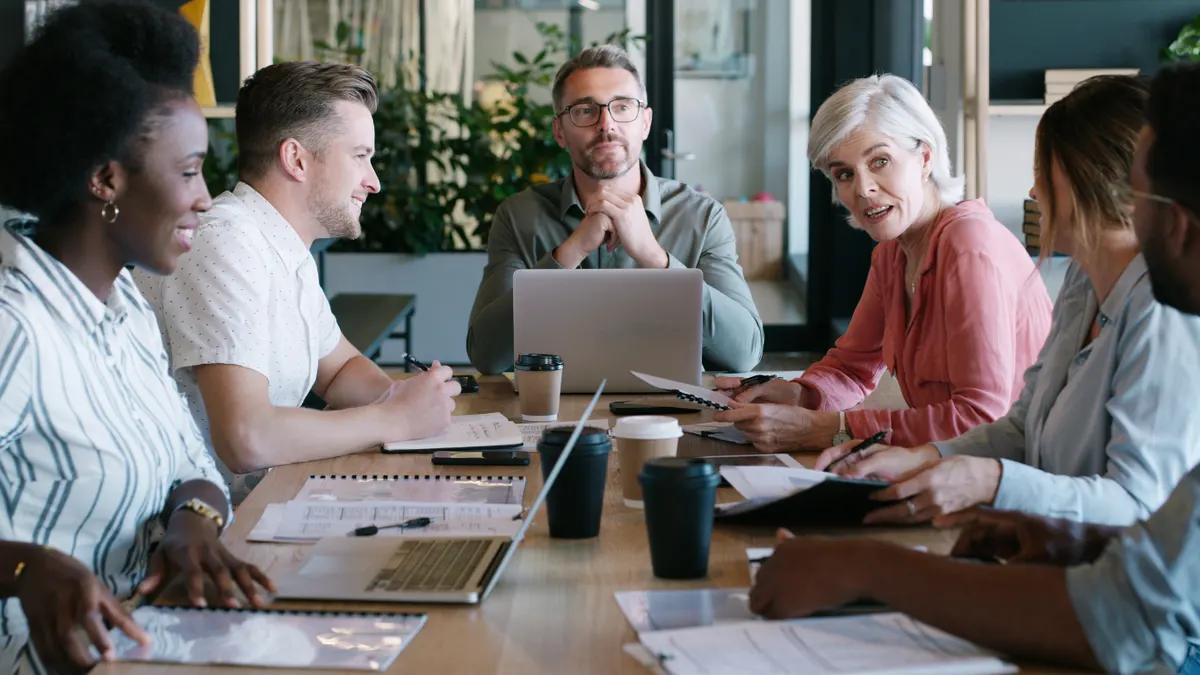 People discussing a business plan around a table